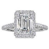 Silver engagement ring with a large rectangular clear gemstone surrounded by smaller diamonds