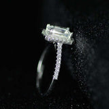 Silver engagement ring with blue sapphire and diamond accents in prong setting
