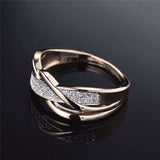 Twisted gold zircon ring for women with prong setting and round zircon stones on 14k yellow gold plated band