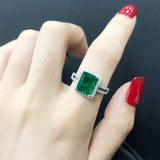 Natural green emerald gemstone ring in 925 sterling silver with princess cut and prong setting on woman's hand