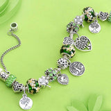 Tree of Life charm bracelet for women with Tibetan silver beads and green floral accents on a beaded chain