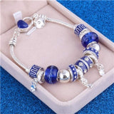 Silver charm bracelet with blue zircon beads and lobster clasp in jewelry box
