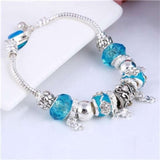 Silver charm bracelet with blue zircon beads and link chain for women
