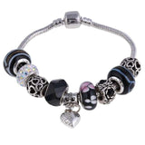 Silver charm bracelet with black, pink zircon, and decorative beads and a heart pendant for women