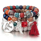 Vintage wristband beaded bracelet for women with colorful beads, silver charms, and red tassel in bohemian style
