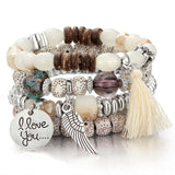 Vintage wristband beaded bracelet for women with silver charms, tassel, and round acrylic beads in bohemian style
