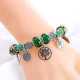 Tree of Life Charm Bracelet for women with green beads and Tibetan silver tree and flower charms