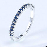 Luxurious women's engagement zircon ring in 18K rose gold with round tension-set blue stones