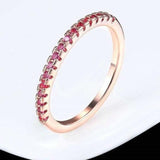 Luxurious engagement zircon ring in 18K rose gold with round red zircon stones in tension setting for women