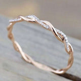 Princess aquamarine ring for women with twisted rose gold plating and small sparkling stones, ideal for engagement or wedding jewelry.