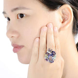 Luxury flower amethyst sterling silver ring with purple enamel worn on woman's hand