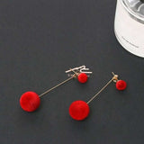 Pair of trendy red velvet round stud earrings with gold-plated push-back design on black background