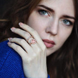 Woman wearing a 10K rose gold morganite engagement ring set with prong setting and rectangular gemstone on hand