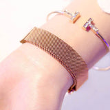 Rose gold Princess Starry Sky Magnet Watch with stainless steel mesh band on wrist, paired with crystal-embellished bracelet