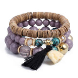 Vintage wristband beaded bracelet for women with wooden, purple, turquoise beads and black tassel charm