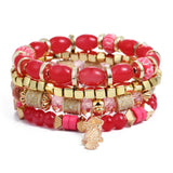 Vintage wristband beaded bracelet for women with red and pink beads, gold accents, and a charm pendant.