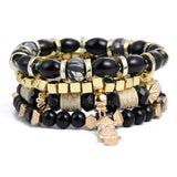 Vintage wristband beaded bracelet for women with black, gold, and patterned beads featuring a small owl charm and bohemian style.