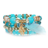 Vintage wristband beaded bracelet for women with turquoise beads, gold charm, and feather detail